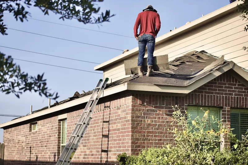 Professional roofer working on a residential roof in East Liberty